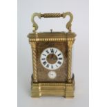 A HARMANN AND KOCH GLASS AND BRASS CARRIAGE ALARM CLOCK the white enamel dial with Roman numerals