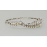A 14K WHITE GOLD PEARL BANGLE set with twenty eight full pearls, inner diameter 5.8cm, weight 13.