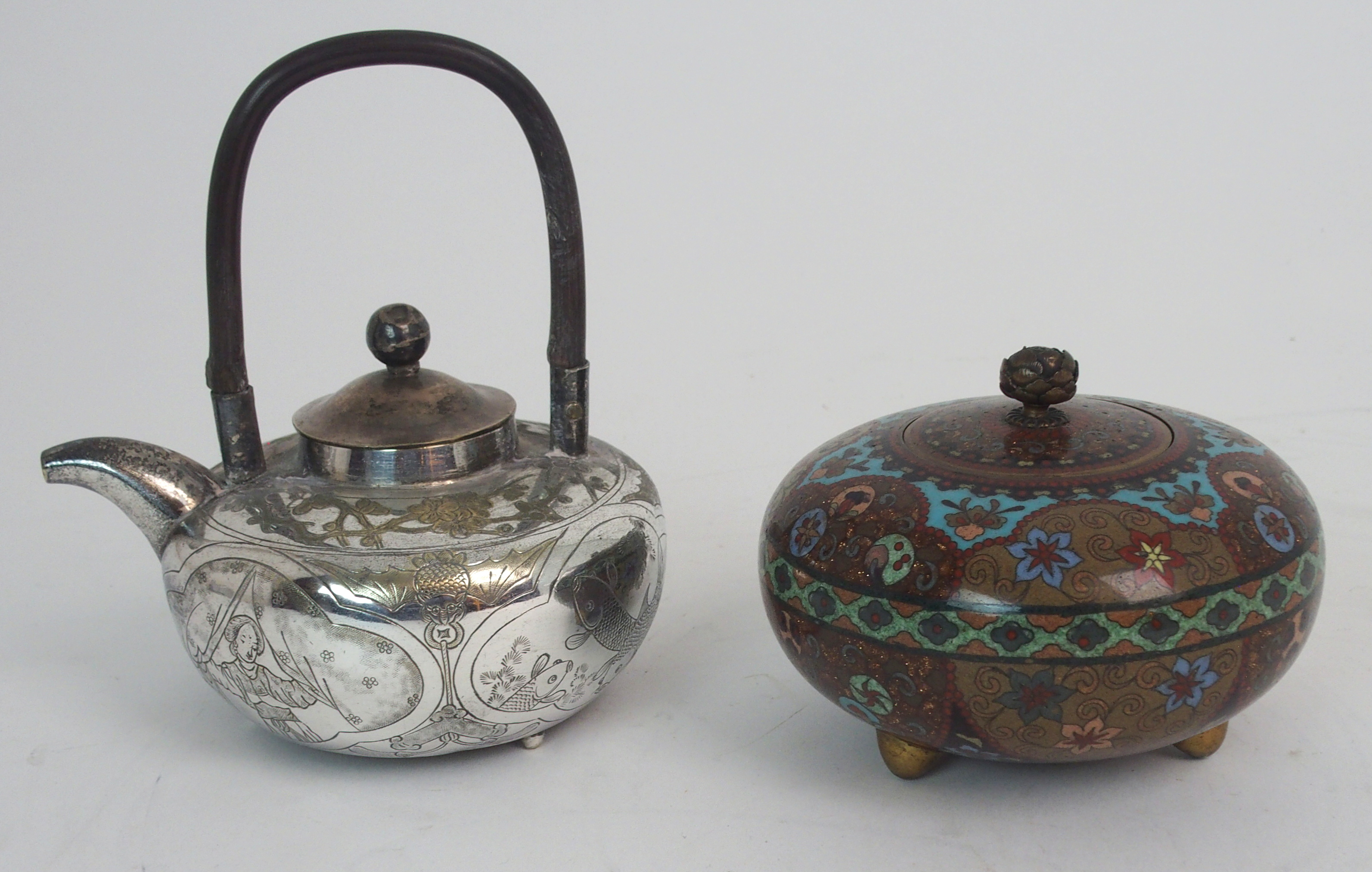 A CHINESE WHITE METAL TEAPOT engraved with panels of fish, birds, foliage and a figure divided by