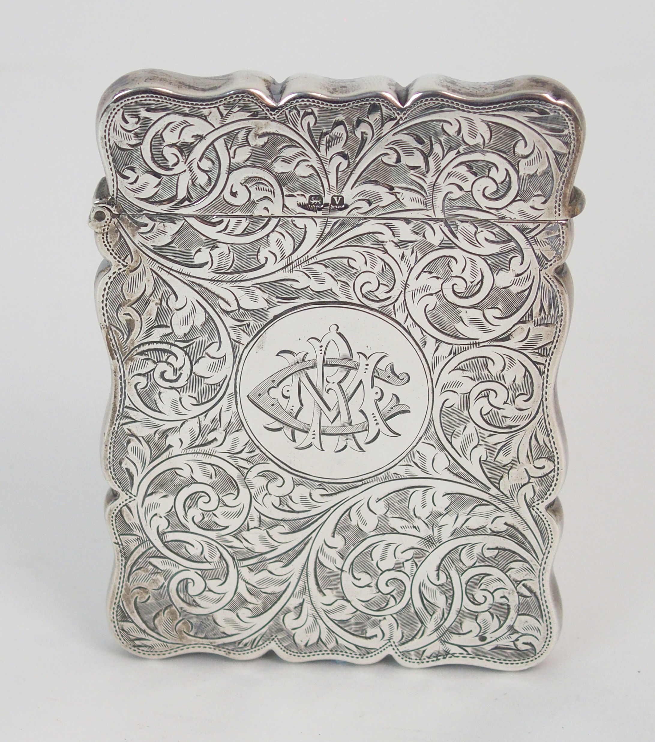 A SILVER CARD CASE by Robert Chandler, Birmingham 1920, of rectangular shape with engraved foliate