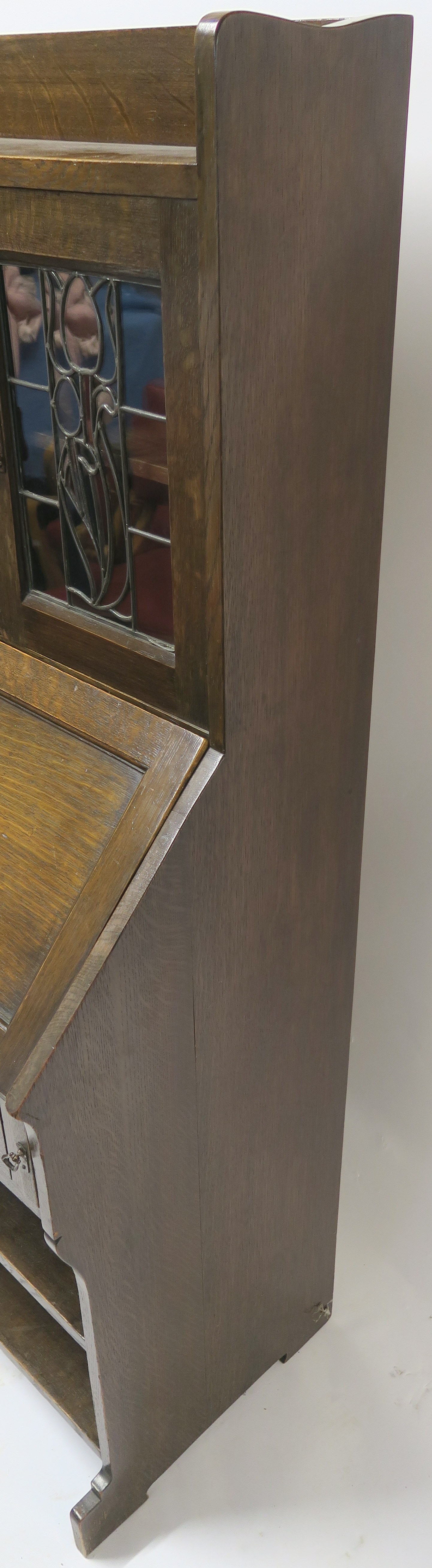 AN ARTS AND CRAFTS OAK WRITING DESK with a stained and leaded glass door and open shelves above a - Image 6 of 8