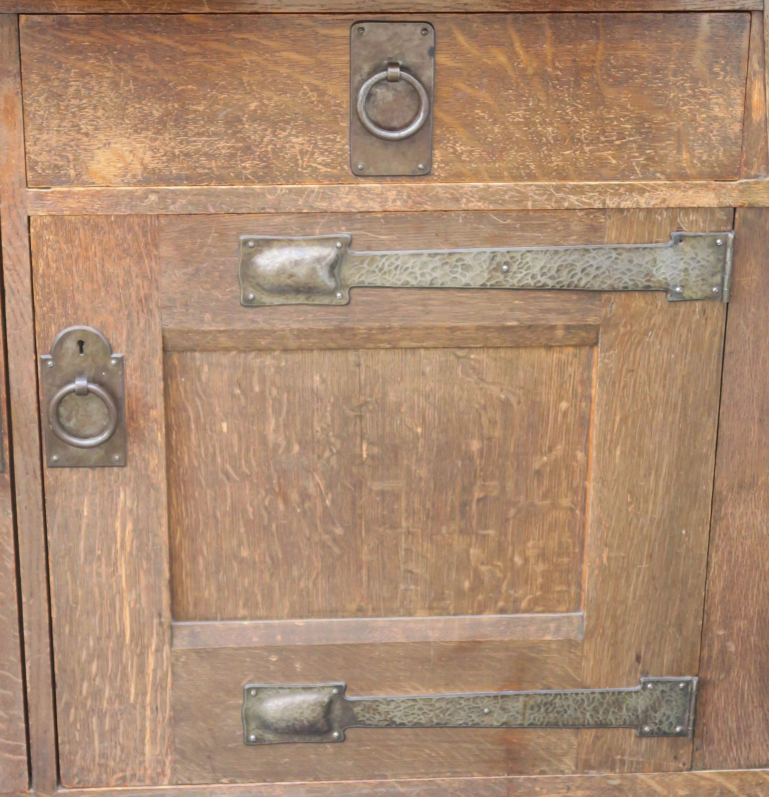 A LIBERTYS OF LONDON OAK ARTS AND CRAFTS SIDEBOARD the overhanging cornice above a leaded glass - Image 14 of 15