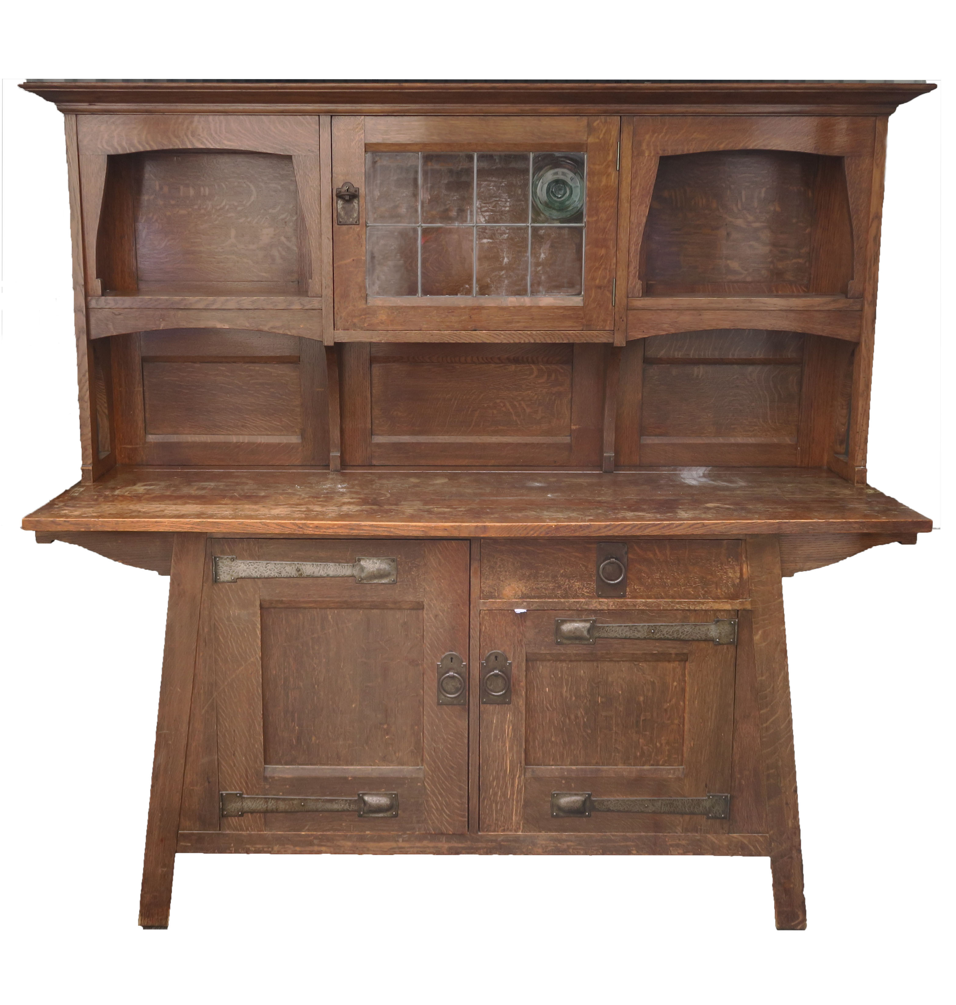 A LIBERTYS OF LONDON OAK ARTS AND CRAFTS SIDEBOARD the overhanging cornice above a leaded glass