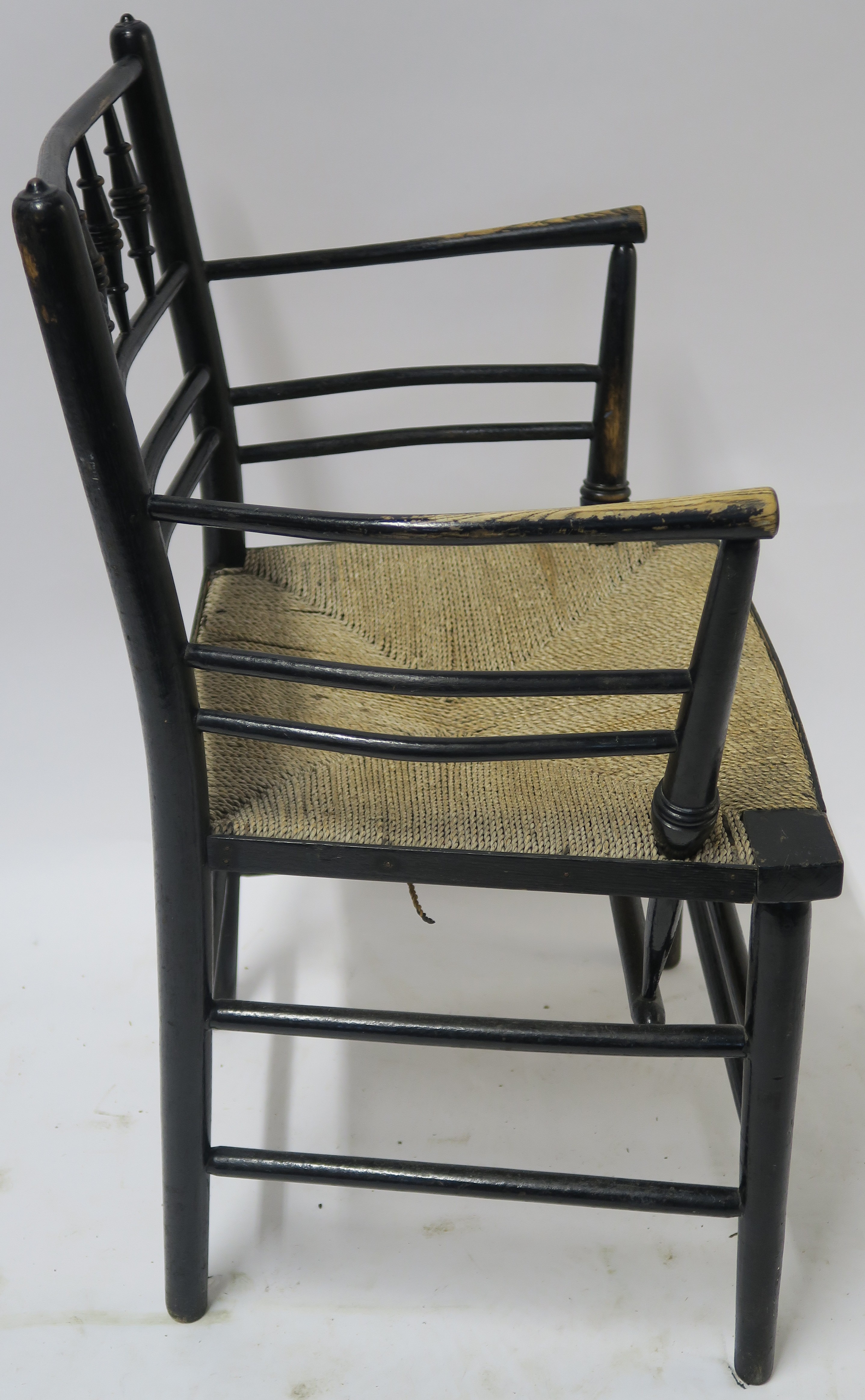 A WILLIAM MORRIS EBONISED SUSSEX CHAIR of standard form with rush seat 85cm high Condition Report: - Image 4 of 7