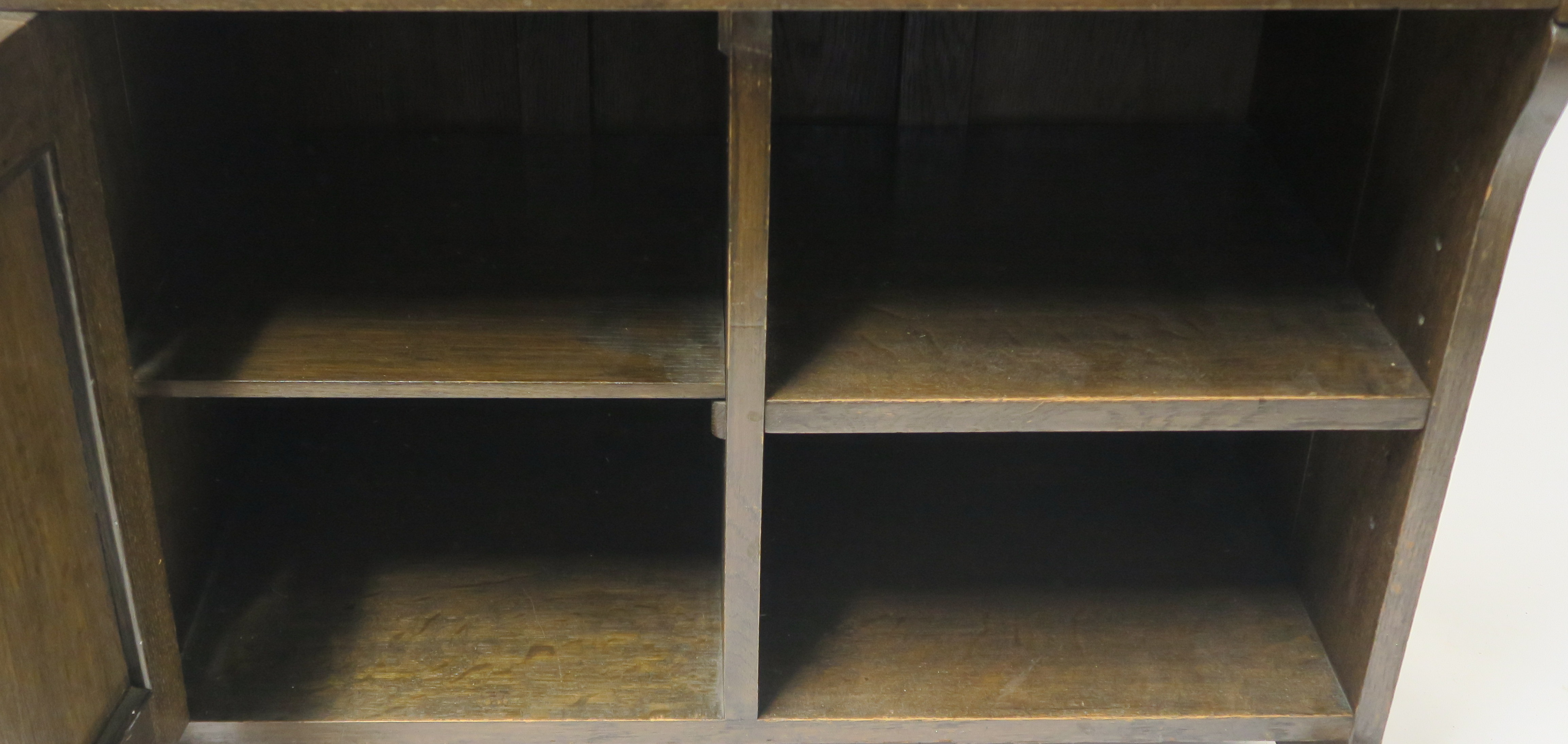 AN ARTS AND CRAFTS OAK WRITING DESK with a stained and leaded glass door and open shelves above a - Image 5 of 8