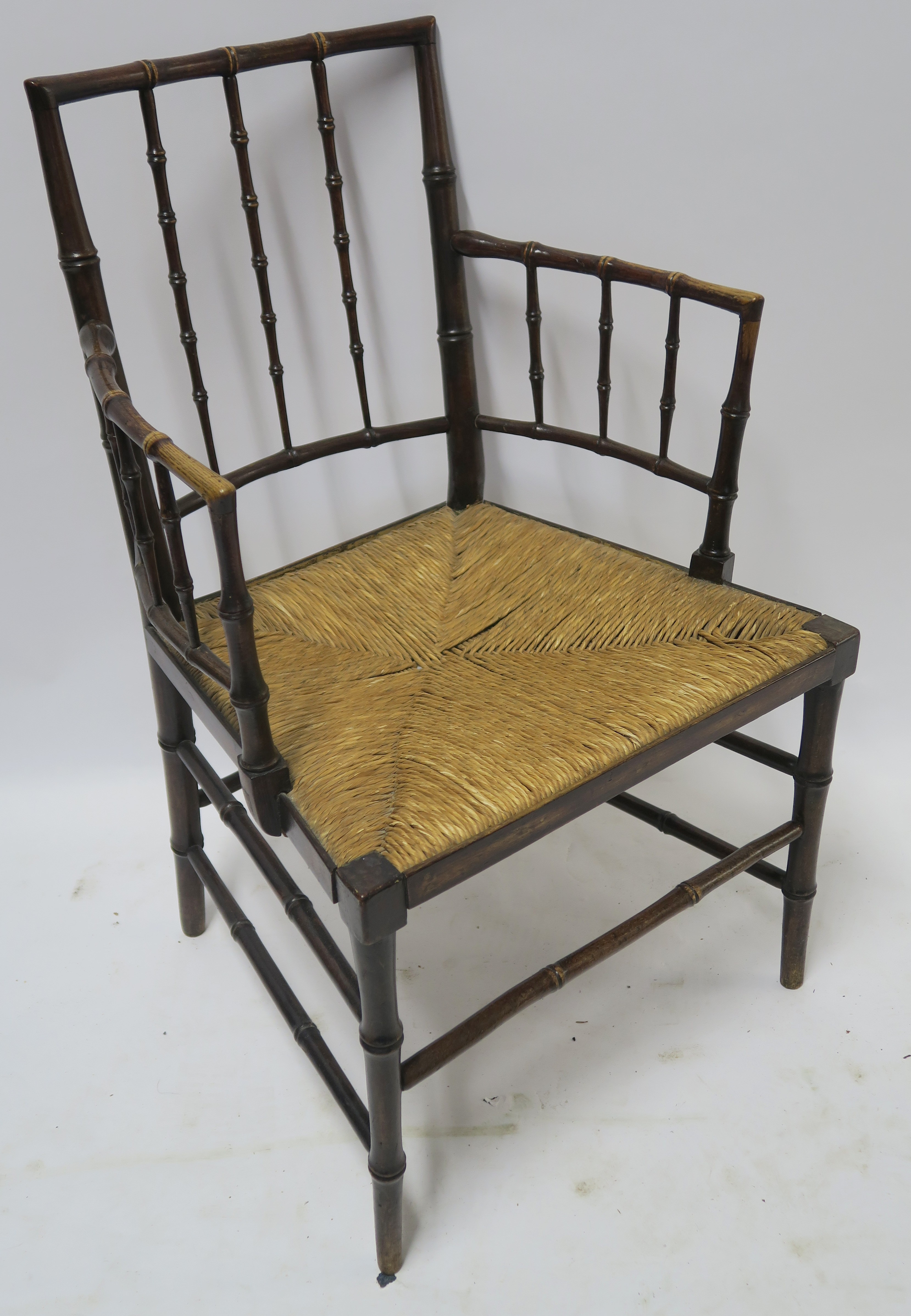 A WILLIAM MORRIS SUSSEX CHAIR of standard form with rush seat, 88cm high Condition Report: