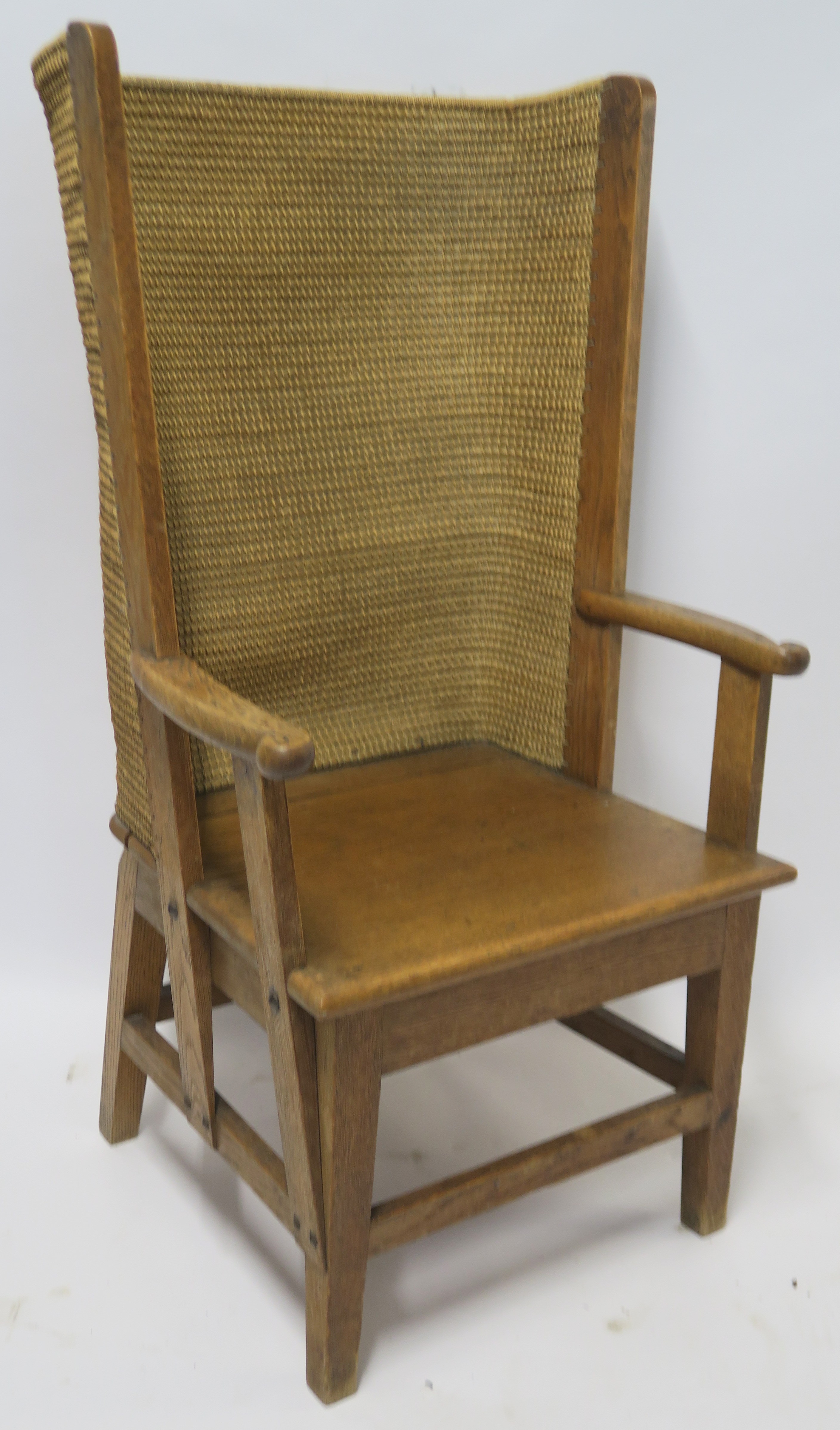 AN ORKNEY OAK AND RUSH ARMCHAIR of standard form, 107cm high, 58cm wide and 55cm deep Condition