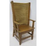 AN ORKNEY OAK AND RUSH ARMCHAIR of standard form, 107cm high, 58cm wide and 55cm deep Condition