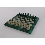 A MINIATURE MALACHITE CHESS SET AND BOARD 19cm square Condition Report: Available upon request