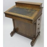 A VICTORIAN INLAID WALNUT DAVENPORT of standard design with four drawers 95cm high, 75cm wide and