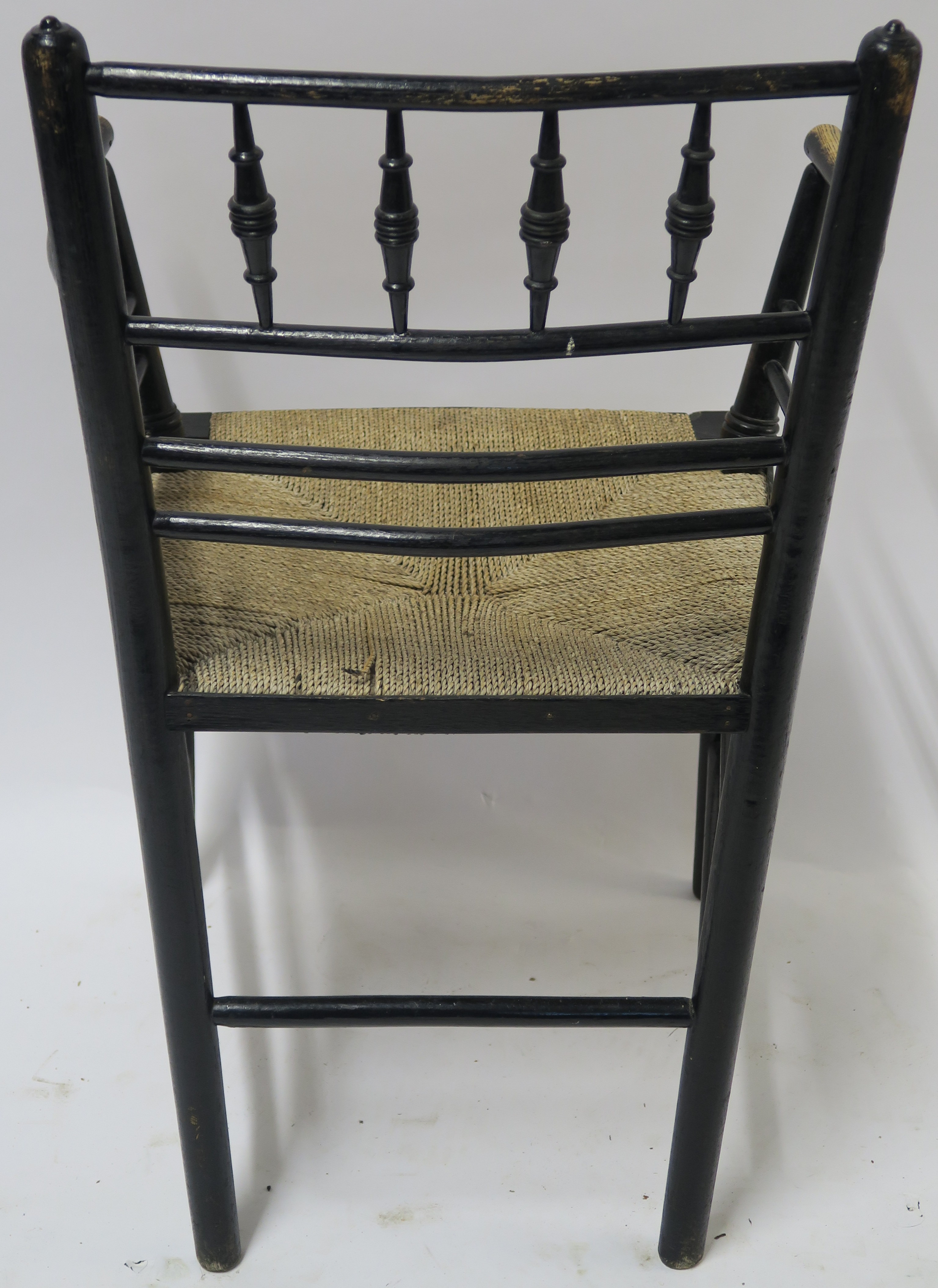 A WILLIAM MORRIS EBONISED SUSSEX CHAIR of standard form with rush seat 85cm high Condition Report: - Image 6 of 7