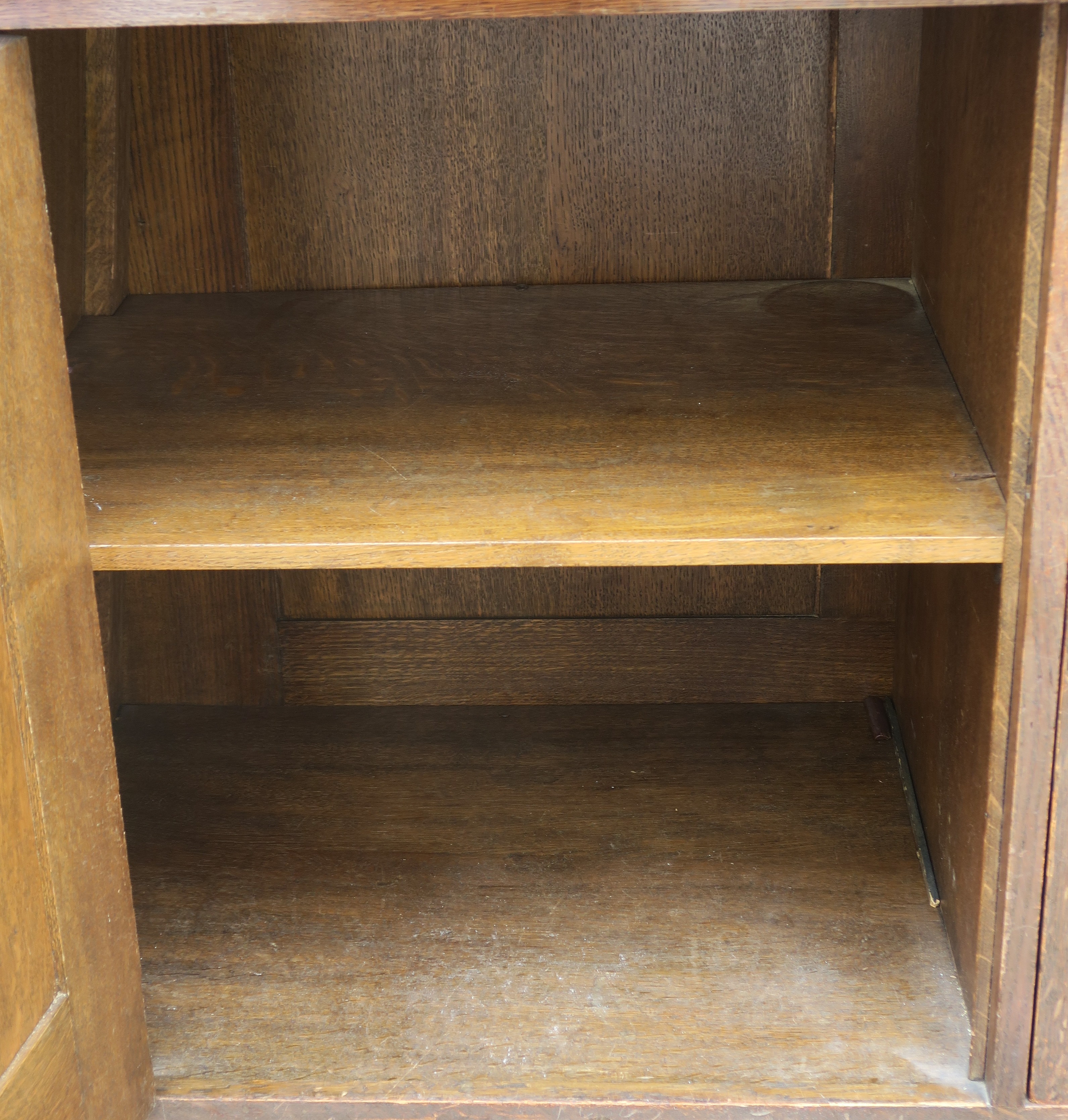 A LIBERTYS OF LONDON OAK ARTS AND CRAFTS SIDEBOARD the overhanging cornice above a leaded glass - Image 12 of 15