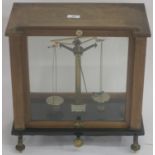 A cased set of scales by Thomson, Skinner and Hamilton, Glasgow, 43cm high x 43cm wide x 26cm deep