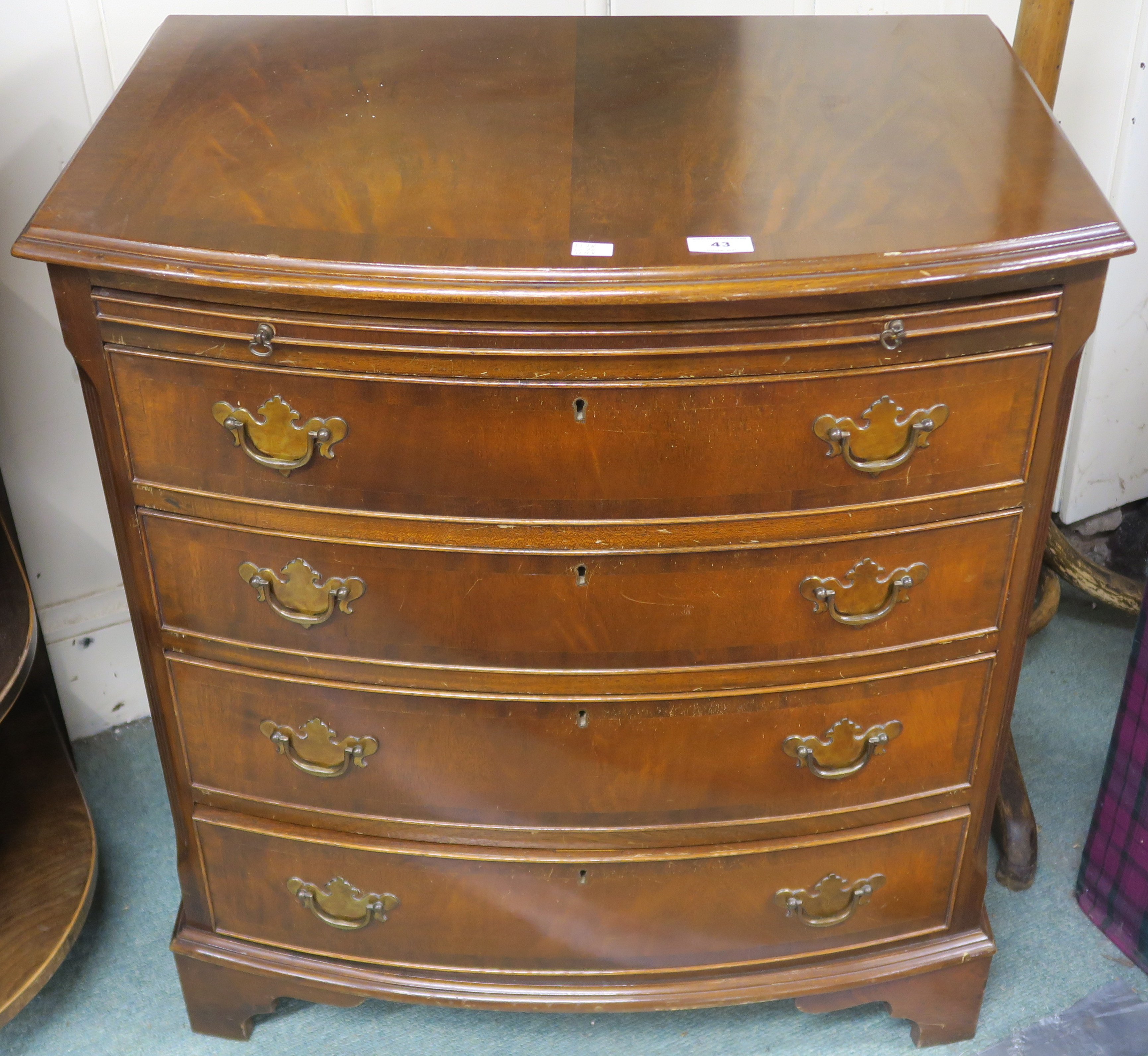 A reproduction mahogany bow front four drawer chest with bracket feet, 78cm high x 70cm wide x