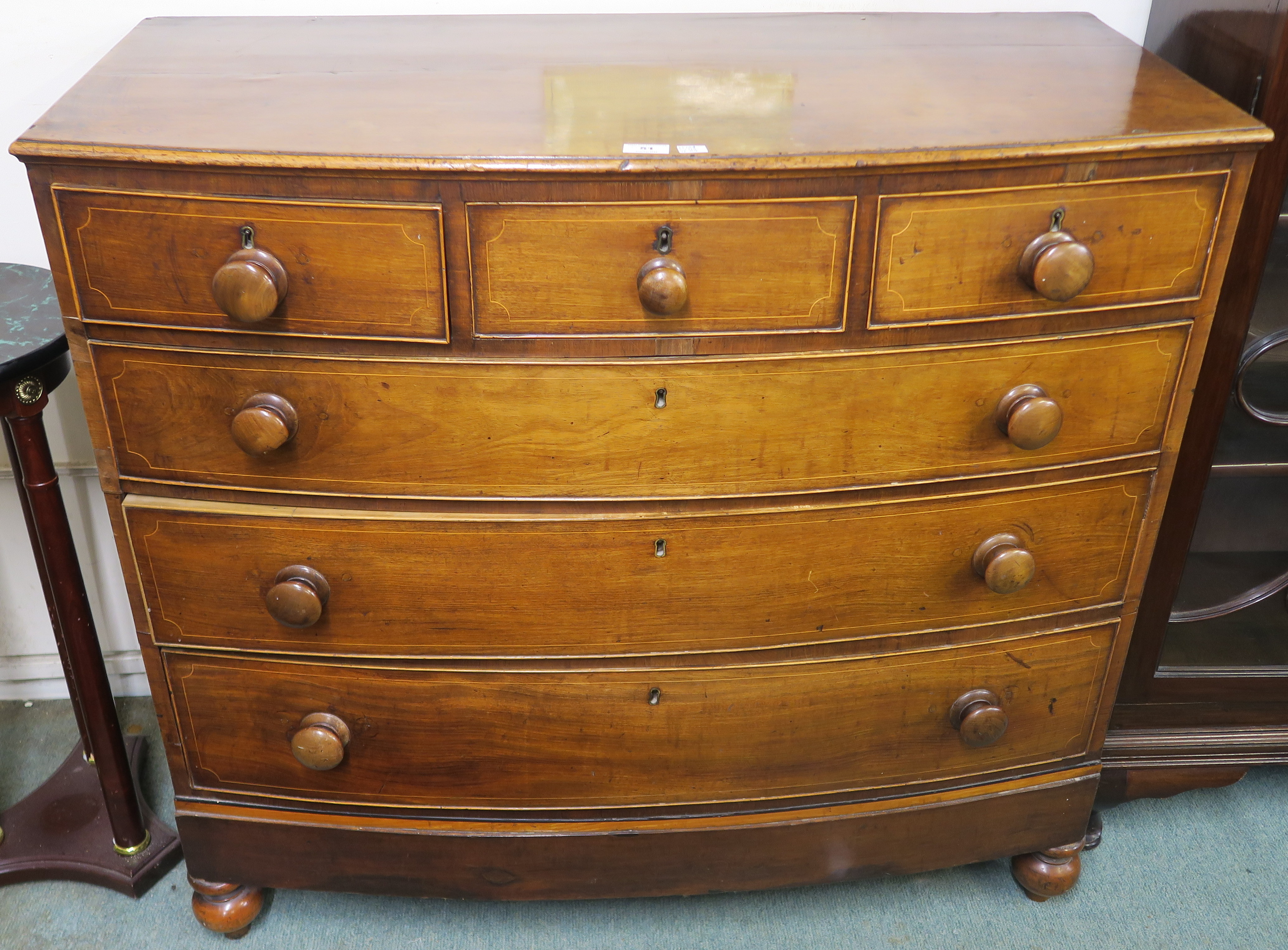 A 19th Century mahogany bow front three over three chest of drawers on turned feet, 101cm high x