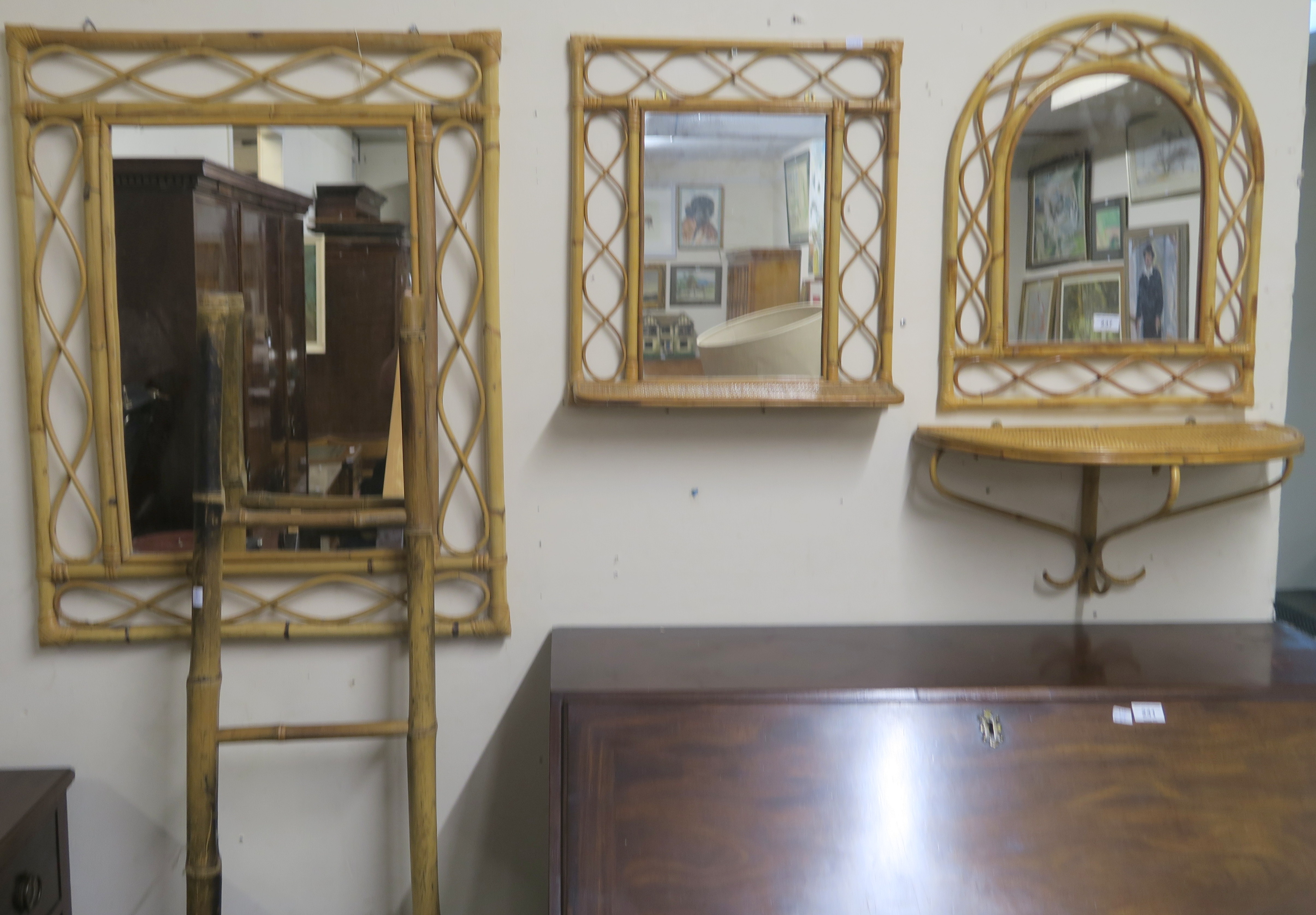 A bamboo ladder, three cane wall mirrors and a wall shelf (5) Condition Report: Available upon