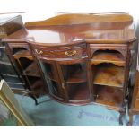 A reproduction mahogany sideboard with bow front with a drawer over two doors flanked by open