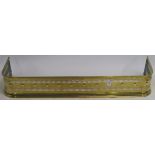 A pierced brass fender, 16cm high x 102cm wide x 32cm deep Condition Report: Available upon request