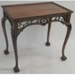 A reproduction mahogany silver table with carved frieze on carved cabriole legs with ball and claw