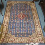 A blue ground eastern rug with central medallion and allover floral design, 187cm x 125cm