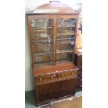 A Victorian mahogany bookcase with two glazed doors over a base with two drawers and two doors