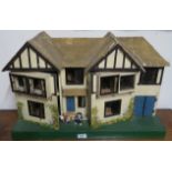 A dolls house with furniture, 42cm high x 68cm wide x 27#cm deep Condition Report: Available upon