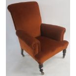 A terracotta upholstered armchair with turned oak legs, 107cm high Condition Report: Available