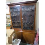 A large Victorian mahogany bookcase with two glazed doors over a base with two doors, 241cm high x