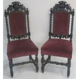 A pair of Victorian oak carved hall chairs, with a carved boars head to the back, barley twist