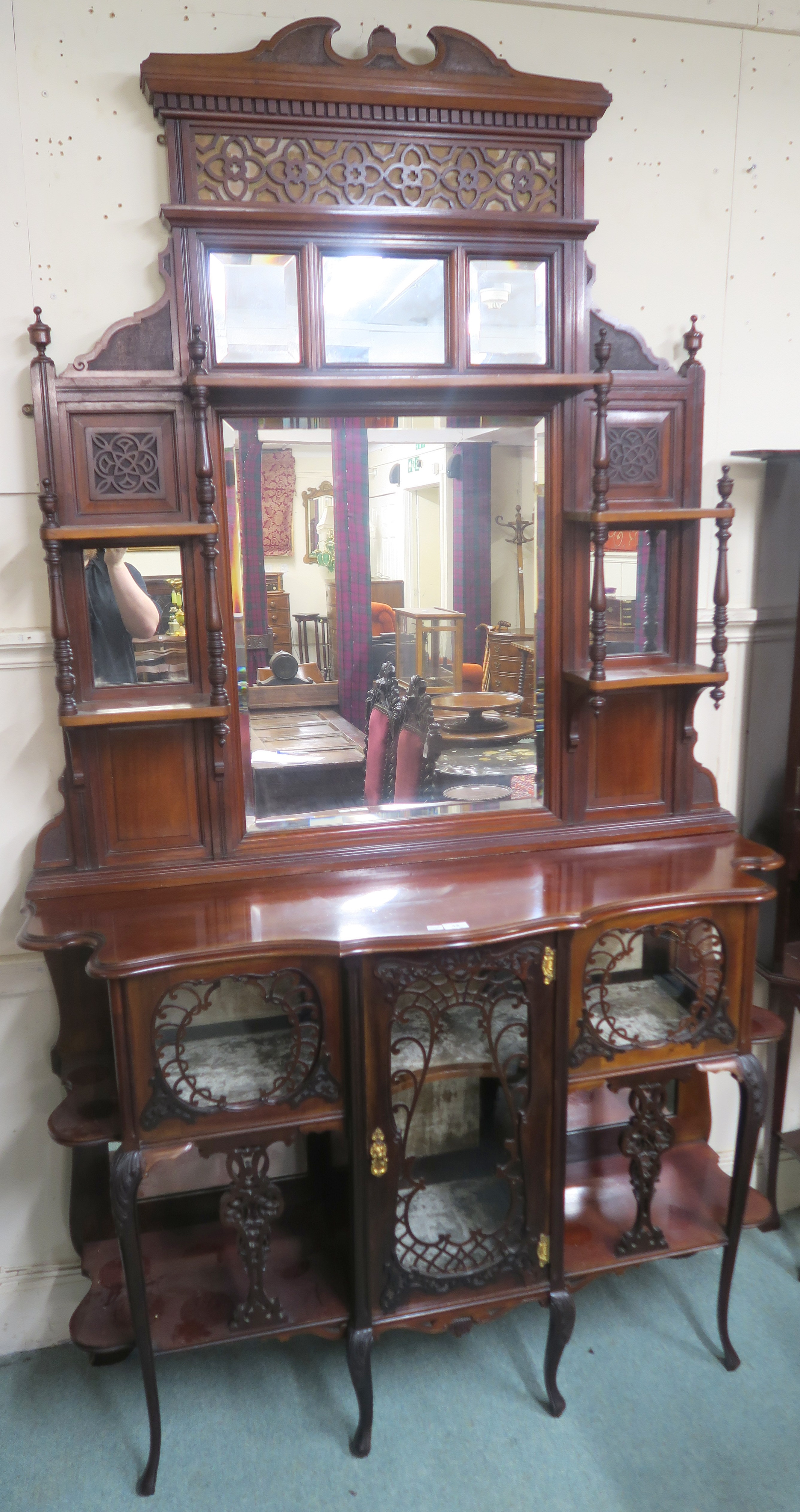 A Victorian mahogany display cabinet with pierced fret work on glazed doors and open shelves with an