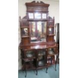 A Victorian mahogany display cabinet with pierced fret work on glazed doors and open shelves with an
