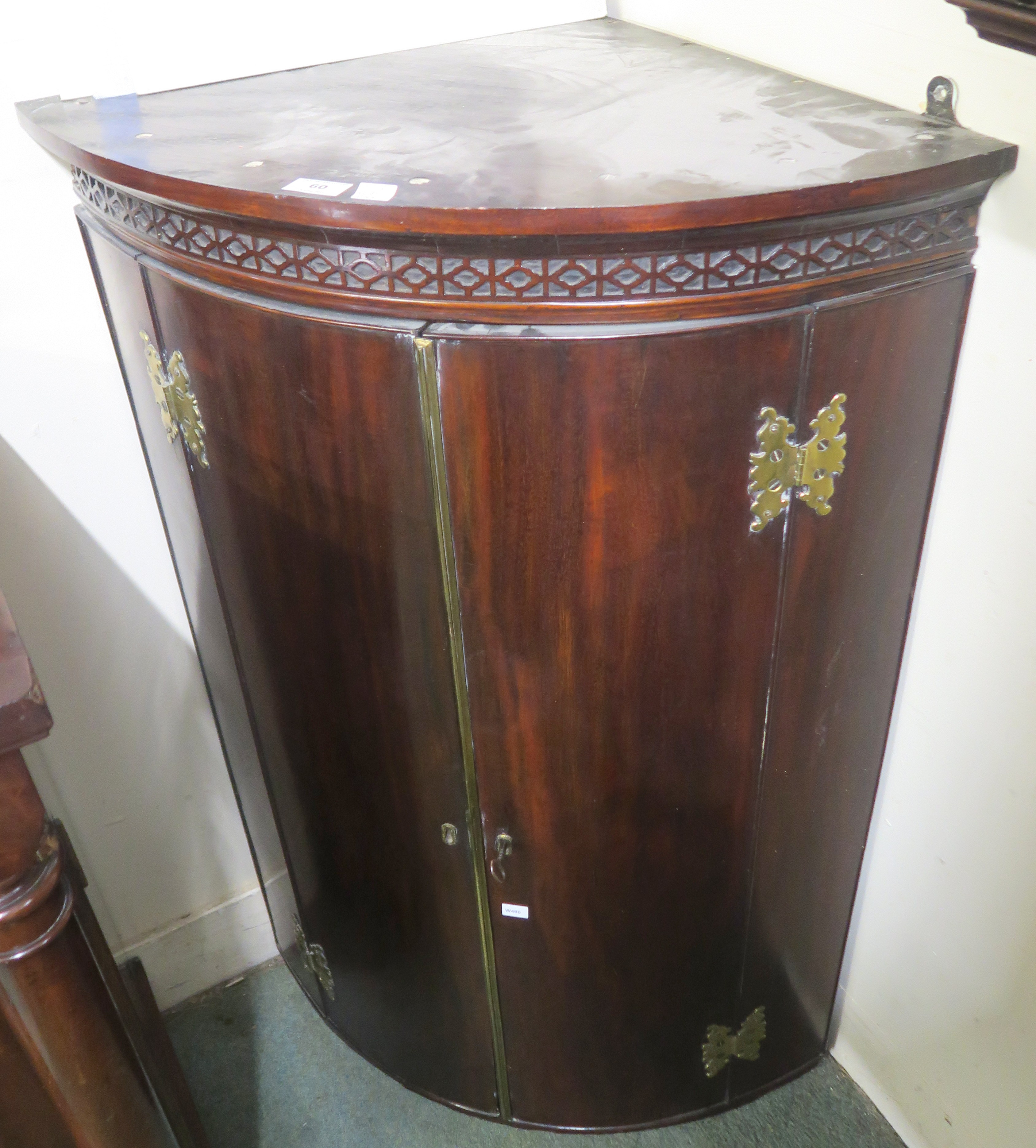 A Georgian mahogany corner cabinet with brass hinges, 108cm high x 71cm wide x 44cm deep Condition