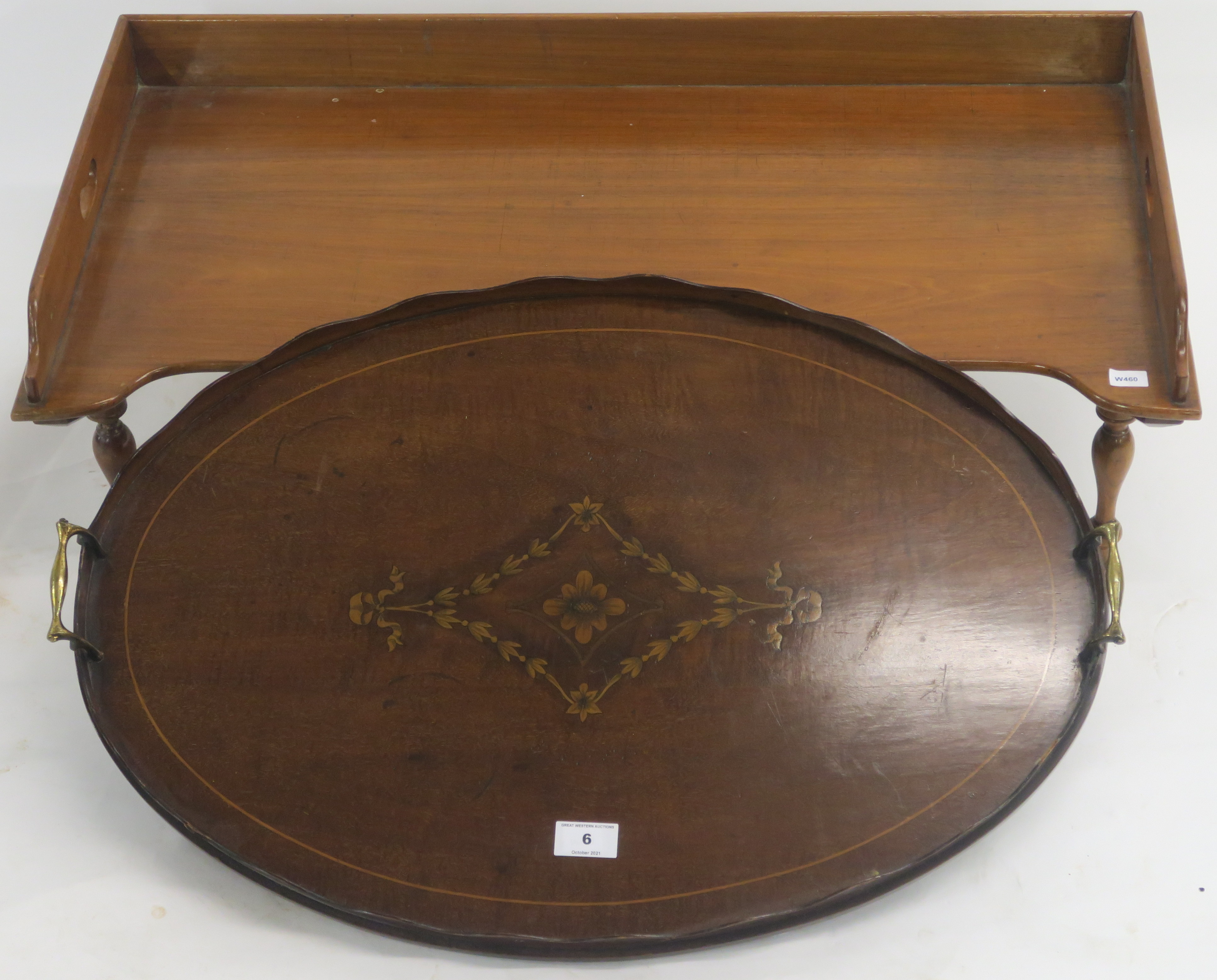 An oval inlaid mahogany tray with brass handles, 66cm wide x 44cm deep and a mahogany bed tray