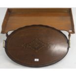 An oval inlaid mahogany tray with brass handles, 66cm wide x 44cm deep and a mahogany bed tray