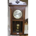 A stained wood wall clock with Roman numerals Condition Report: Available upon request