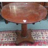 A Victorian circular tilt top table with octagonal column support and quatrefoil base, 79cm high and