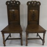 A pair of 20th century carved oak hall chairs, 114cm high (2) Condition Report: Available upon