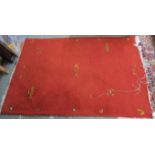 A lot comprising a red ground eastern rug 180cm long and 122cm wide, a pink ground rug 140cm long