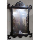 A small Georgian style mahogany framed wall mirror. 50cm high and 34cm wide. Condition Report: