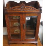 An early 20th century carved oak smokers cabinet Condition Report: Available upon request