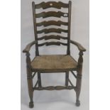 An early 20th century oak ladder back armchair with rush seat, 108cm high Condition Report: