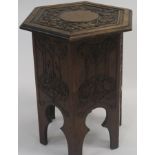A carved oak hexagonal occasional table with hinged top. 53cm high, 46cm wide and 39cm deep. And a