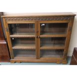 A 20th century oak two door glazed bookcase, 97cm high x 121cm wide x 27cm deep Condition Report: