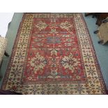 An Afghan Kazak red ground rug with cream borders, 290cm long and 225cm wide Condition Report: