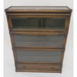 Globe Wernicke oak cased three tier sectional bookcase with single drawer, 105cm high x 87cm wide