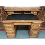 A 20th century oak roll top desk, 104cm high x 122cm wide x 67cm deep Condition Report: Available