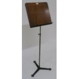 A 19th century walnut and brass adjustable music stand on cast iron tripod base, 120cm high