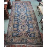 A blue ground eastern rug with multicoloured border, 380cm long x 179cm wide Condition Report: