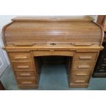 A 20th century oak Francis Smith roll top desk "presented to the Rev Thos Blaney by the members of