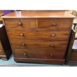 A Victorian mahogany two over three chest of drawer with turned handles, 105cm high x 115cm wide x